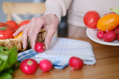 Cropped hands of person preparing food on table