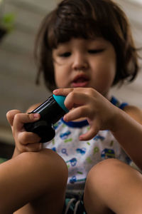 Boy looking away while sitting indoor