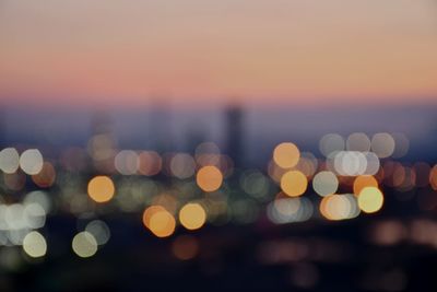 Defocused image of illuminated city at night