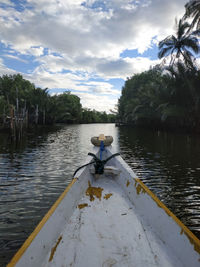 Man in boat on lake against sky
