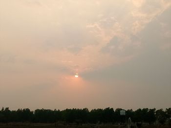 Scenic view of trees against sky during sunset