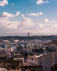 High angle view of city against cloudy sky