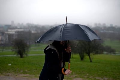 Close-up of a man with umbrella