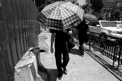 Woman standing on footpath