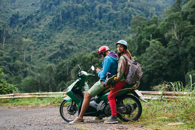 Side view of a young woman riding bicycle