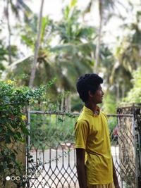 Side view of a boy looking at plants