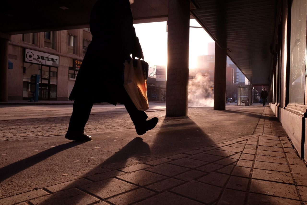 architecture, built structure, lifestyles, full length, walking, rear view, building exterior, men, tiled floor, sunlight, street, person, sidewalk, leisure activity, standing, architectural column, shadow, cobblestone