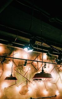 Low angle view of illuminated pendant light hanging from ceiling