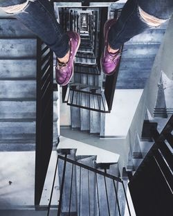 Low section of man standing on staircase