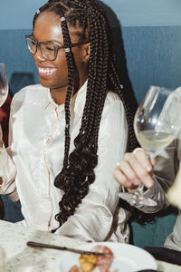 Happy young woman having alcohol in bar