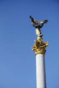 Low angle view of statue against sky