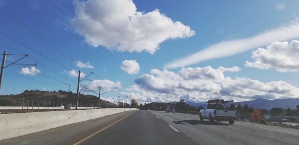 Cars on road against sky