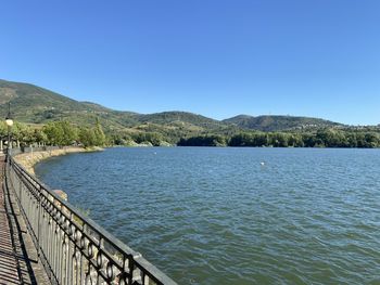 Scenic view of lake against clear blue sky