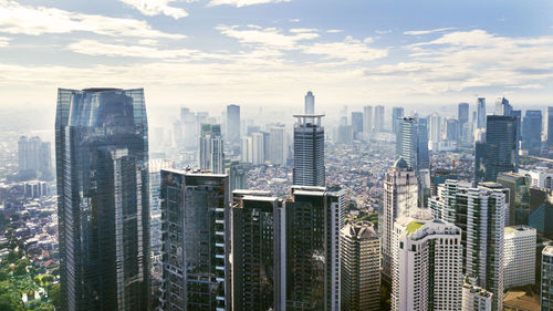 Aerial view of modern buildings in city against sky