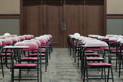 Empty chairs and tables in row