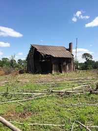 Abandoned house on grassy field