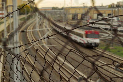 Train seen through chainlink fence