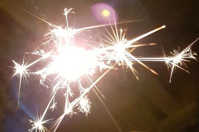 Low angle view of firework display at night