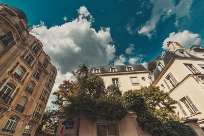 Low angle view of buildings in town against sky