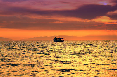 Scenic view of sea against orange sky