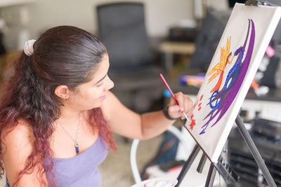 Close-up of young woman painting