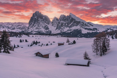 Scenic view of snow covered mountains against sky during sunset