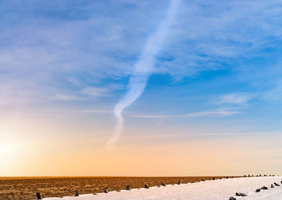 Scenic view of vapor trail against sky during winter