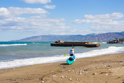 Man surfing in sea against sky