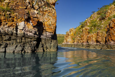 Scenic view of rock formation in sea against sky