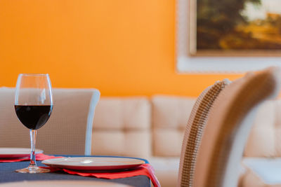 Close-up of wine glass on table at home