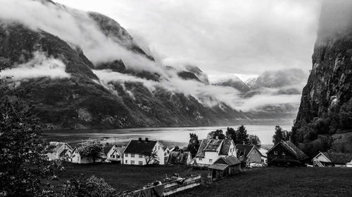 Panoramic shot of sea by mountain against sky