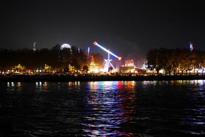 Illuminated ferris wheel at night