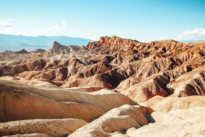 Rock formations on landscape against sky