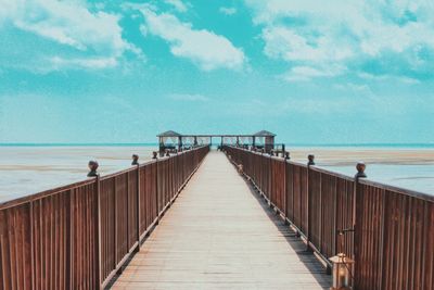 Pier over sea against sky