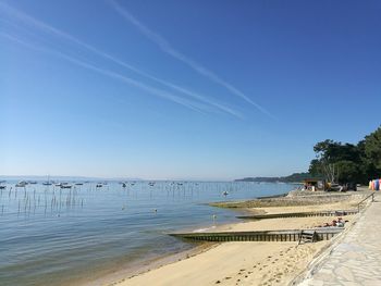 Scenic view of beach against clear blue sky