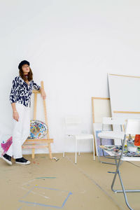 Young female artist in her painting studio