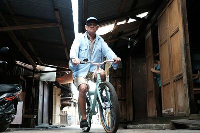 Young man riding bicycle