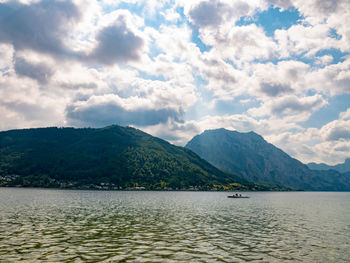 Scenic view of sea and mountains against sky