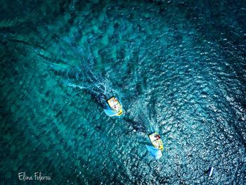 High angle view of people swimming in sea