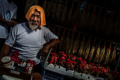 Tilt portrait of mature vendor