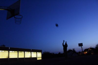 Low angle view of basketball hoop against blue sky