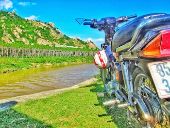 Motorcycle on field against sky