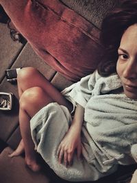 High angle view portrait of woman relaxing on floor