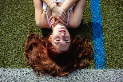 High angle view of woman lying on floor