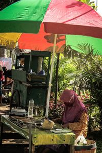 Woman working at market stall