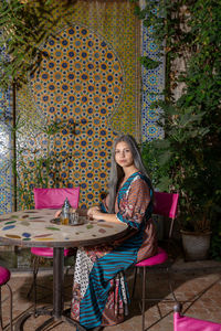 Woman sitting on chair at table