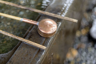 Close-up of spoon at holy water fountain