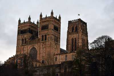 Low angle view of historic durham cathedral against sky