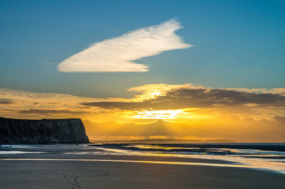 Scenic view of beach against sky during sunset