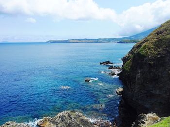 Scenic view of sea against cloudy sky